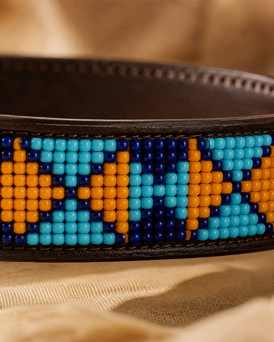 Macro close-up of turquoise, cobalt and amber Maasai beadwork on the Savanna Bay leather dog collar
