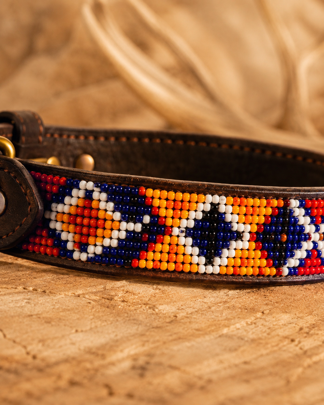 Macro close-up of orange, cobalt, white and red Maasai beadwork on the Savanna Ember leather dog collar