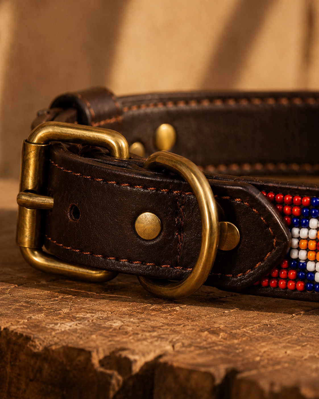 Close-up of dark brown leather and antique brass hardware on the Savanna Ember dog collar