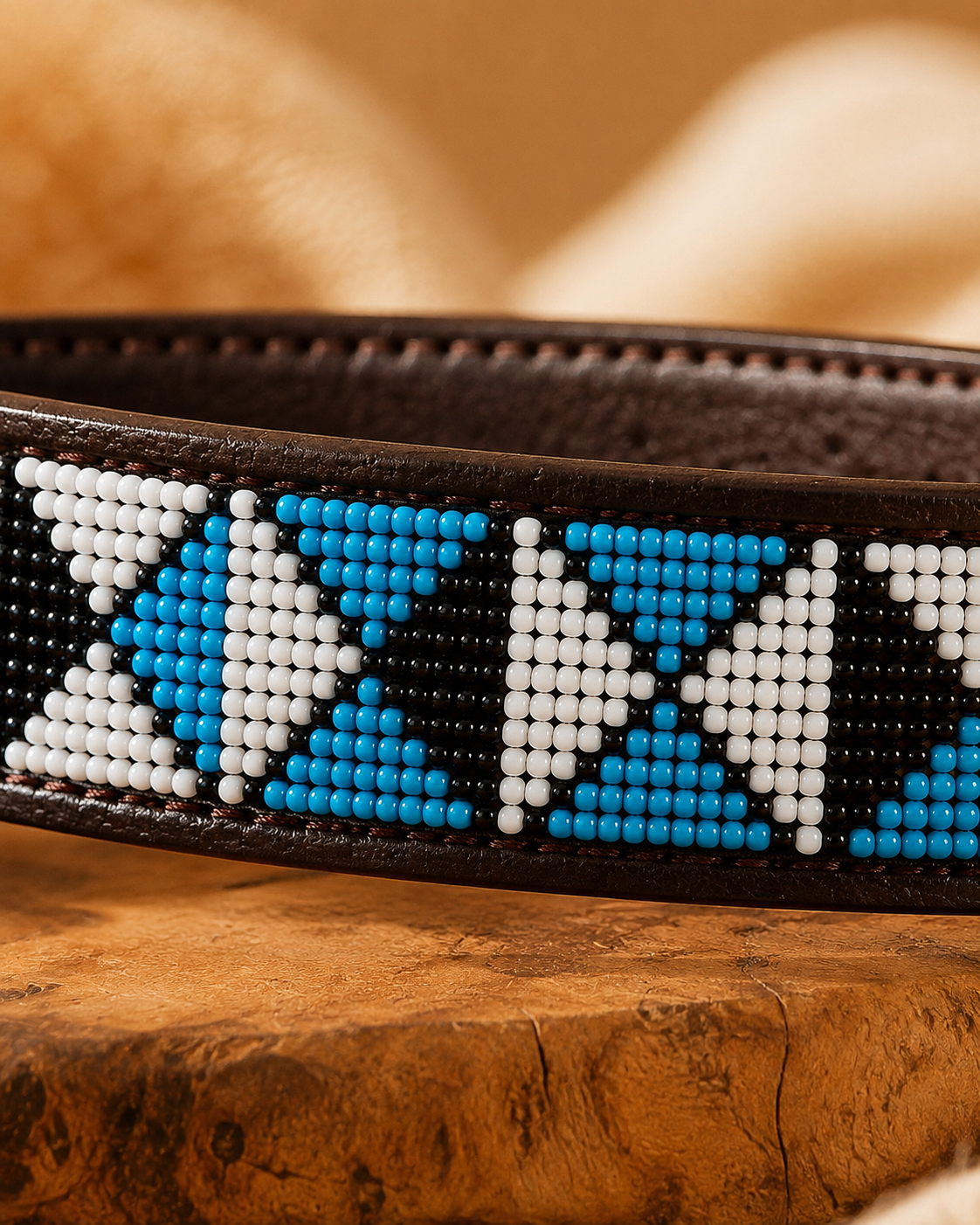 Macro close-up of turquoise, white and black Maasai beadwork on the Savanna Lagoon leather dog collar