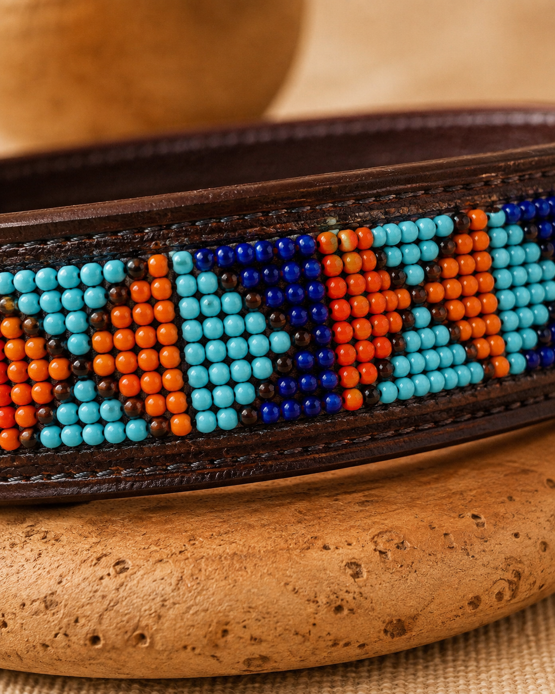 Macro close-up of turquoise, cobalt, orange and red Maasai beadwork on the Savanna Reef leather dog collar